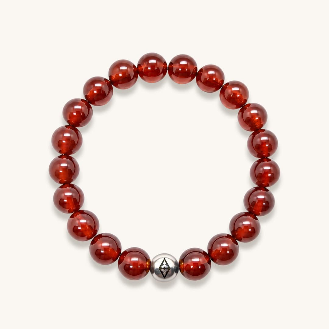 Garnet Gemstone Bracelet Garnet gemstone bead bracelet with silver accents on a white background